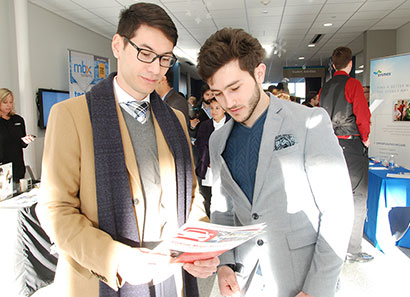 Students reviewing brochure at a job fair