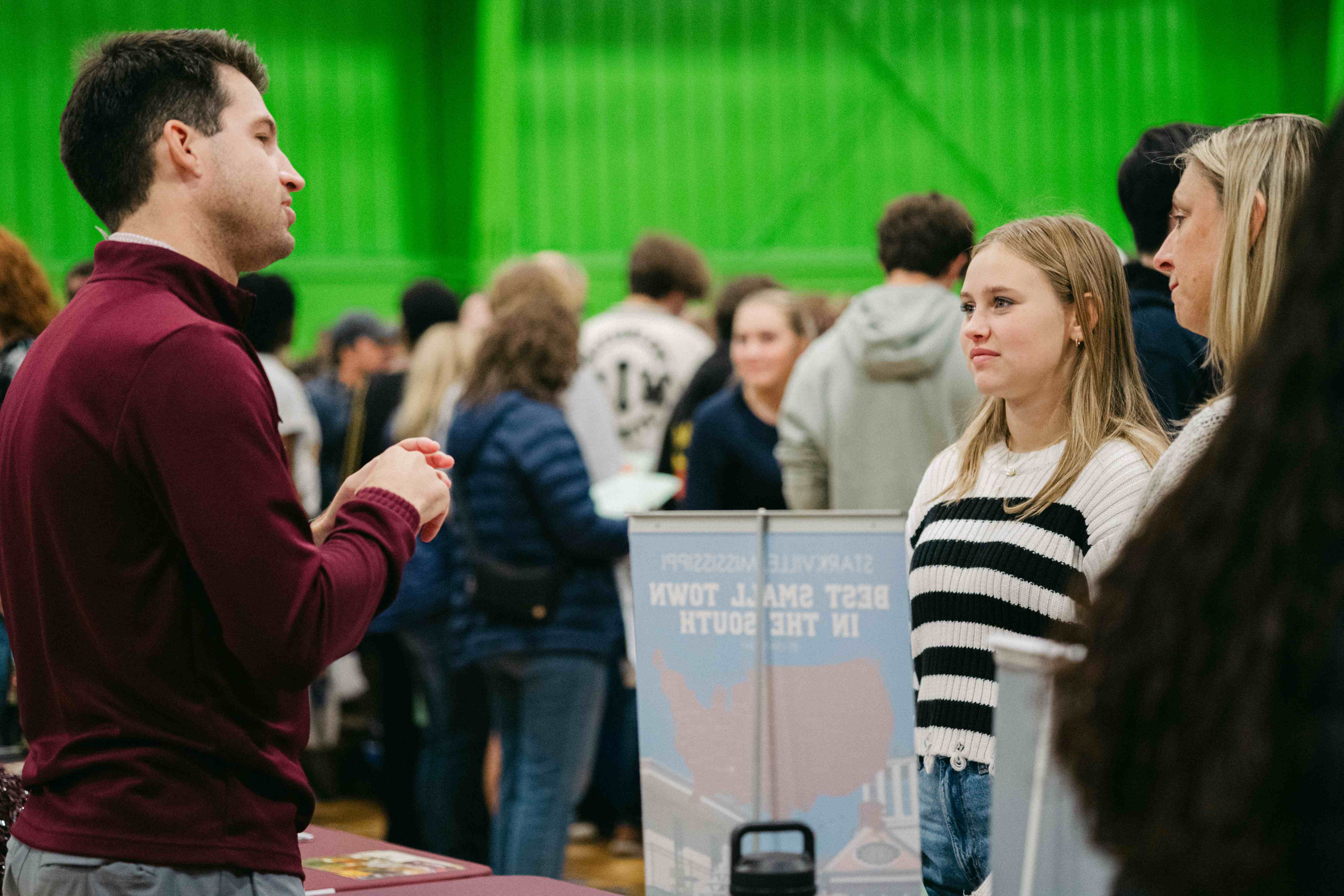 A student talking to a rep at the college fair