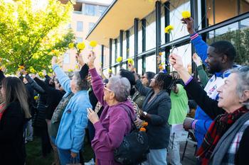 People outside the Urban farm raising flowers