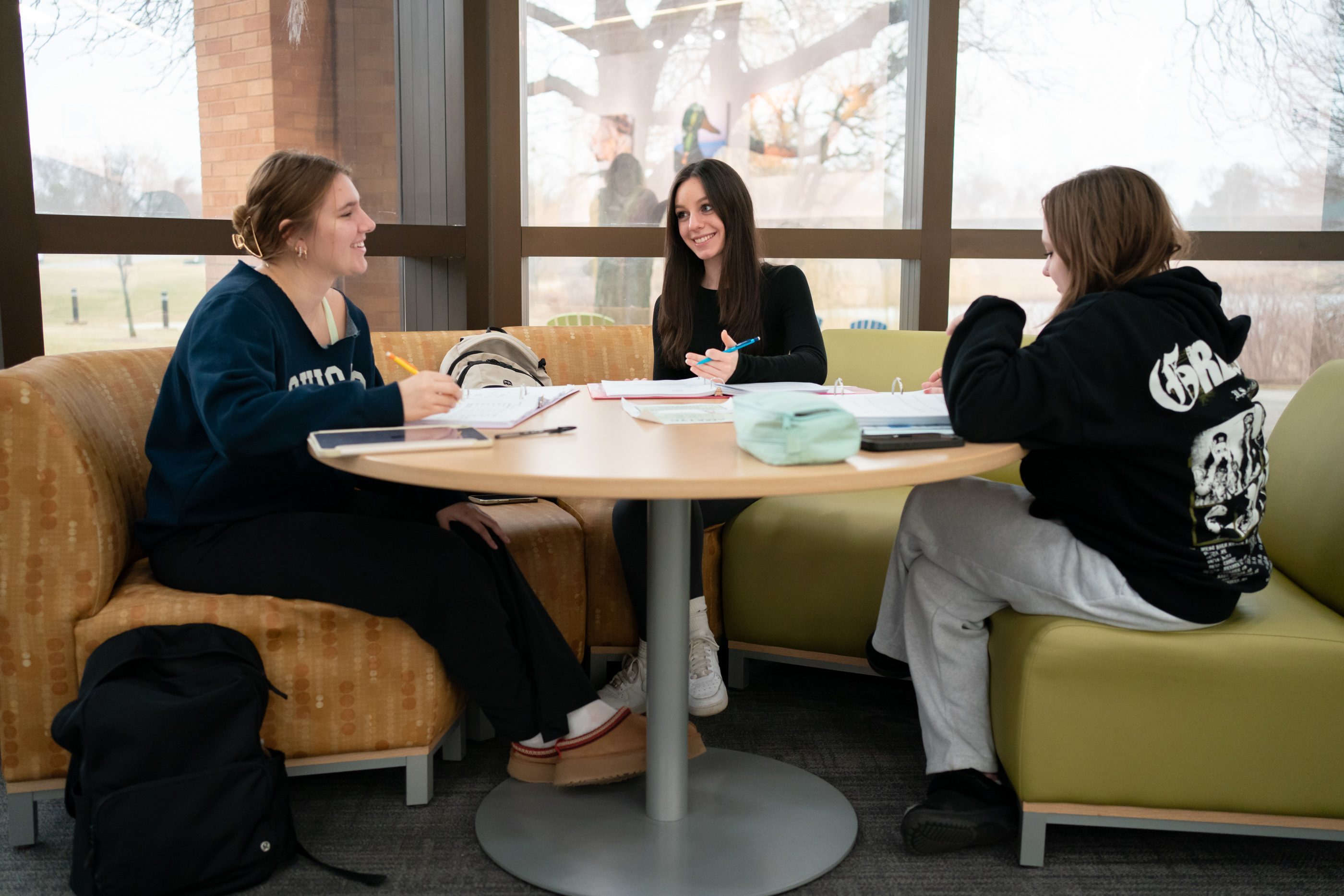 Students sitting together at a table on campus