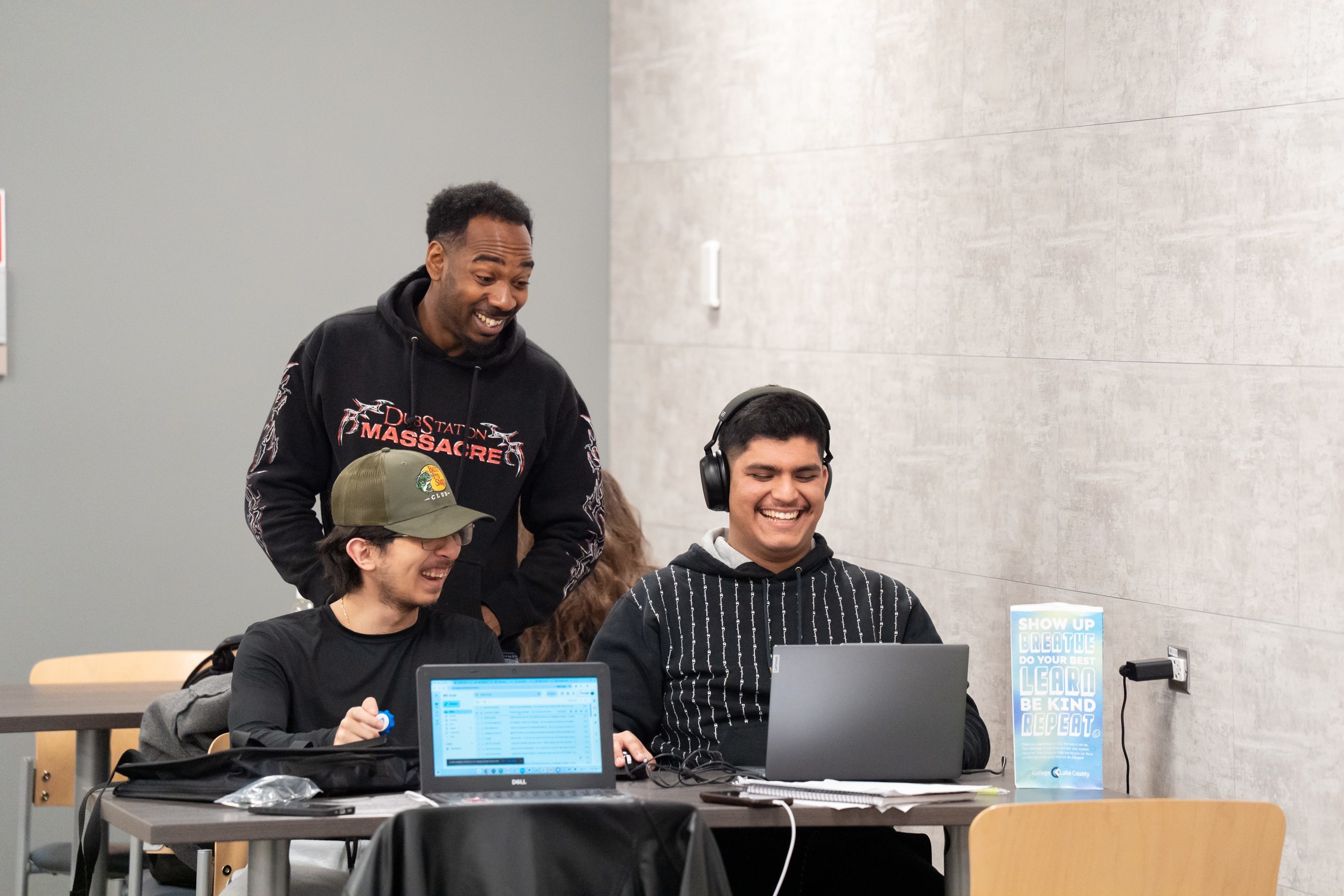 Students talking together around a computer