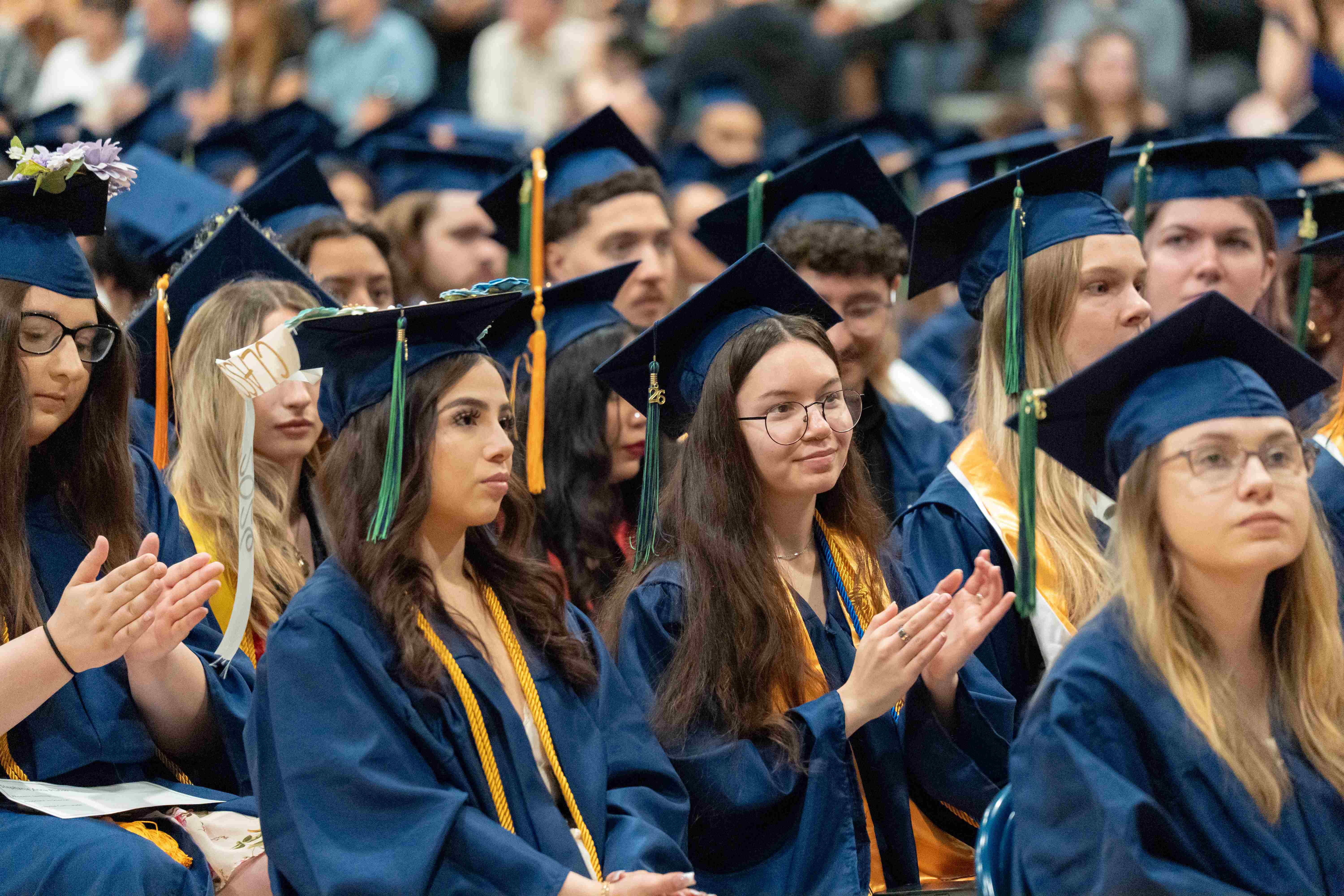 Students sitting in the crowd at graduation