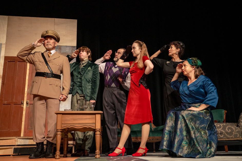 Actors on stage doing a scene from the play