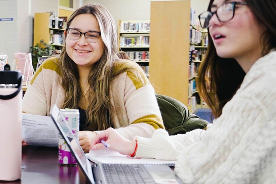 Two students working and studying together at a table