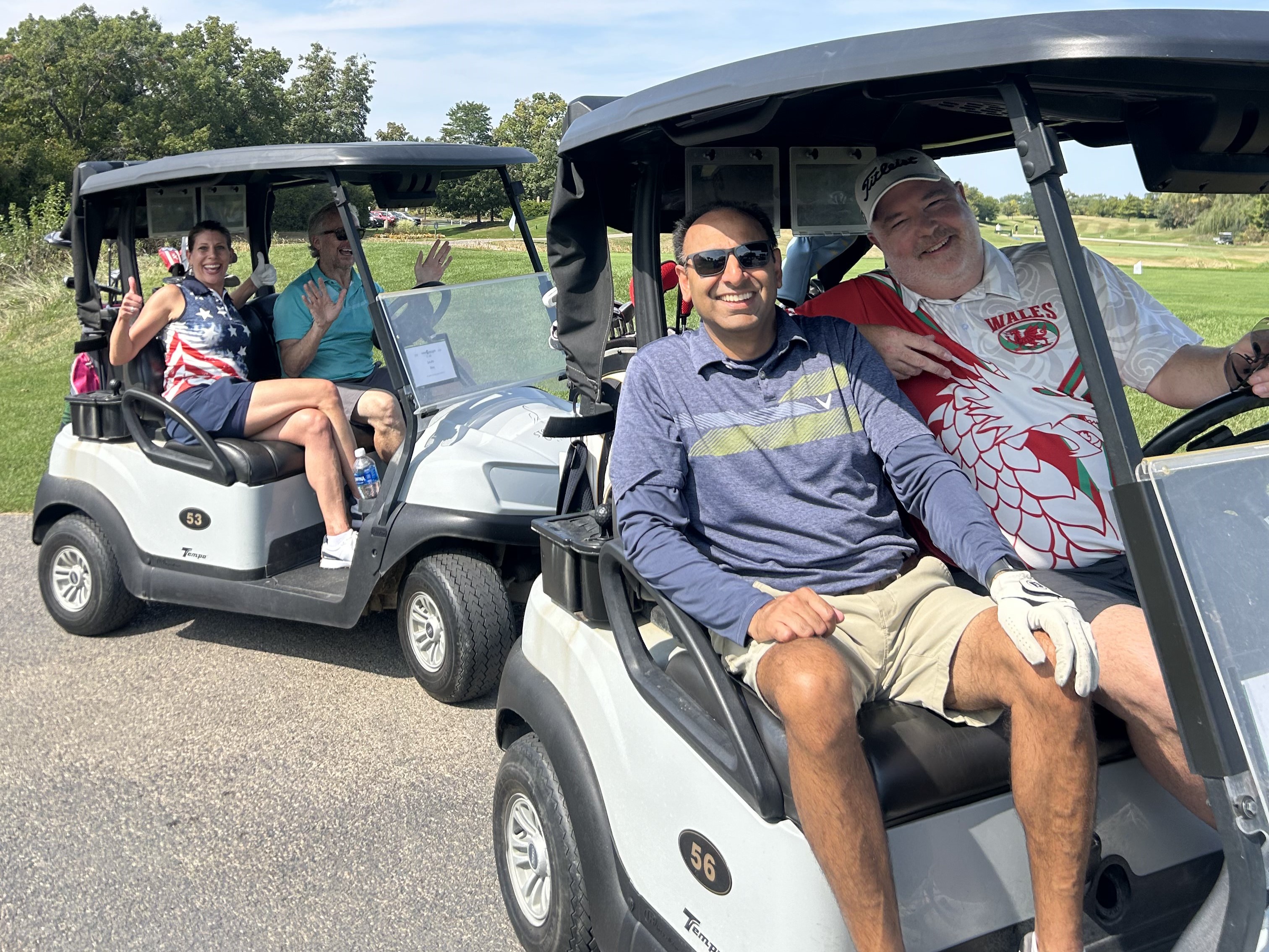 Some golfers driving golf carts