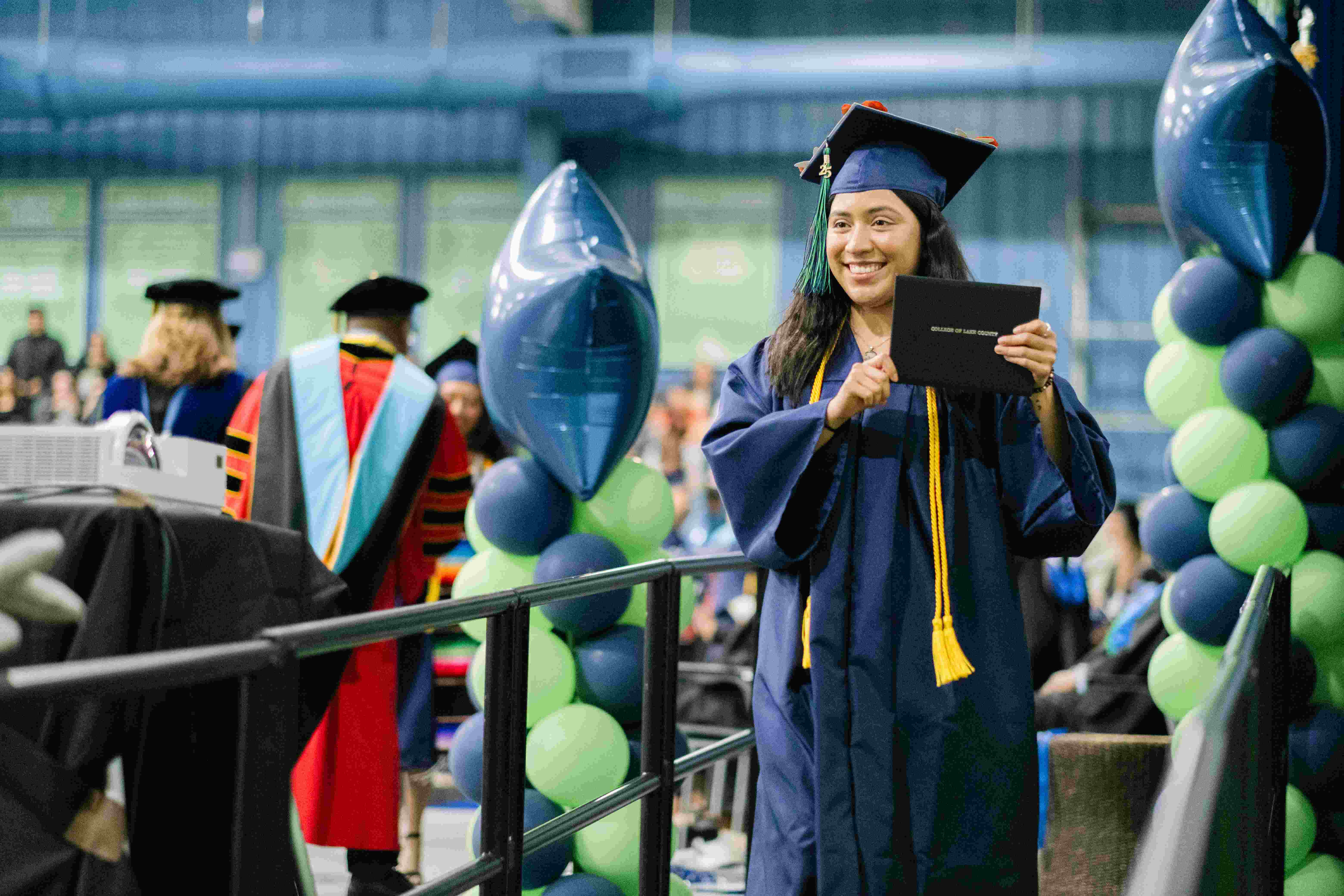 A graduate with their diploma