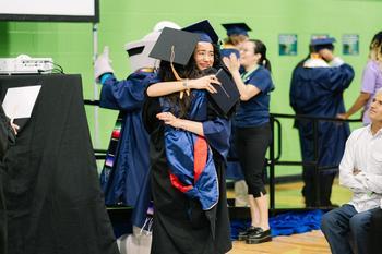 A graduate embracing someone