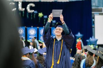 A student walking with his diploma