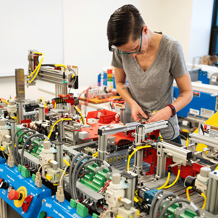 Student working on high-tech equipment in Mechatronics lab in Waukegan, Ill.