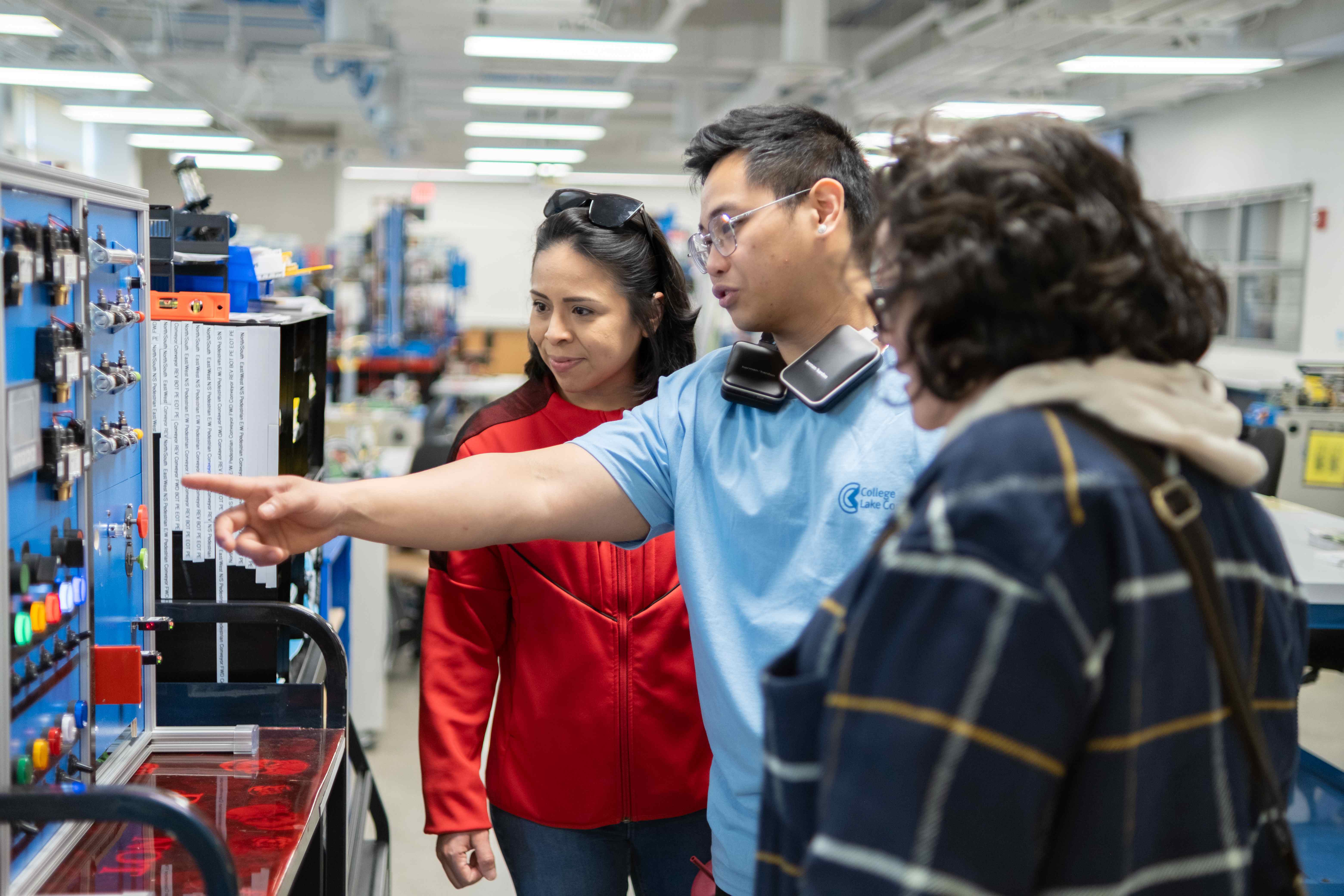 A CLC faculty member shows a community member equipment
