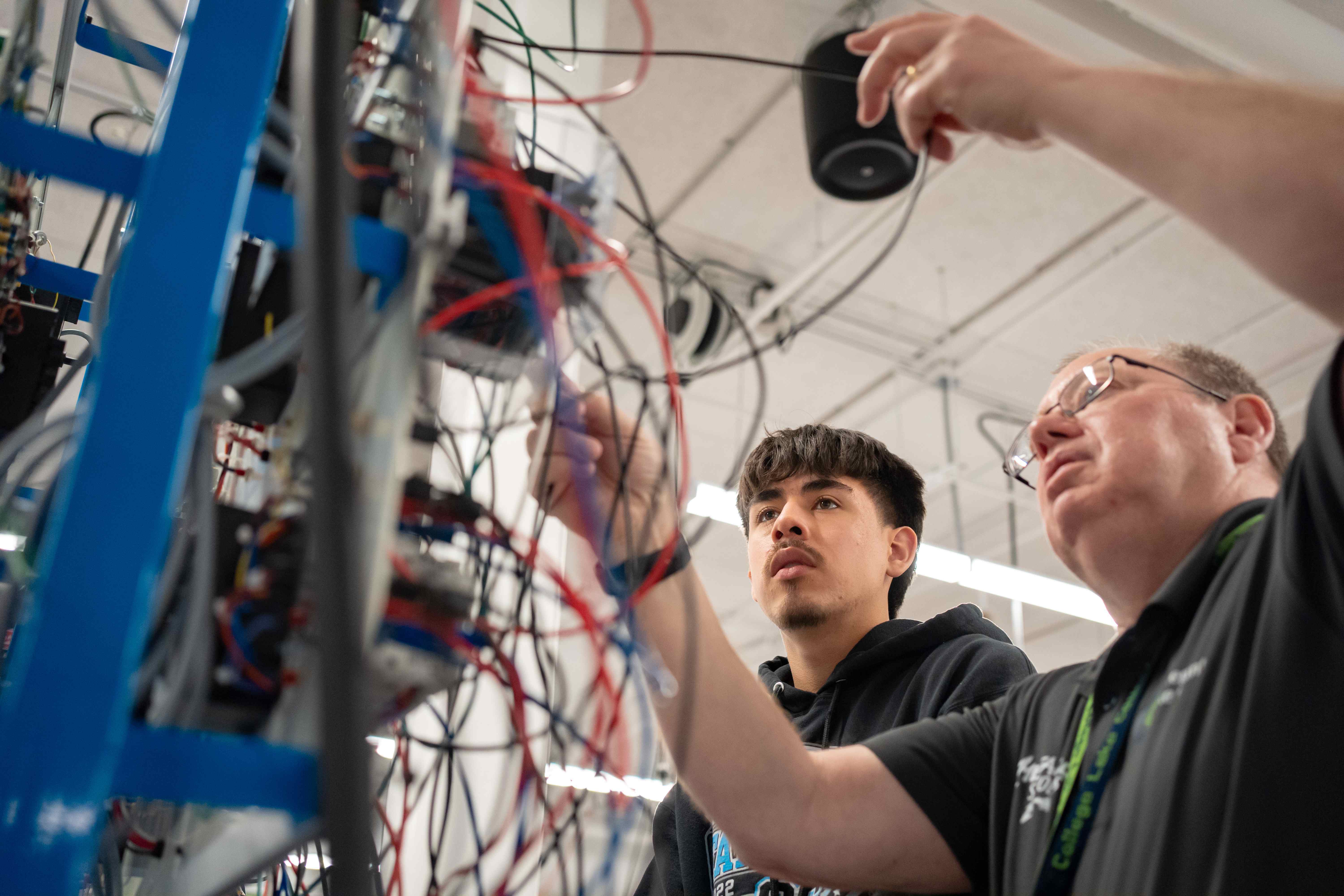 An instructor helping a student with wiring