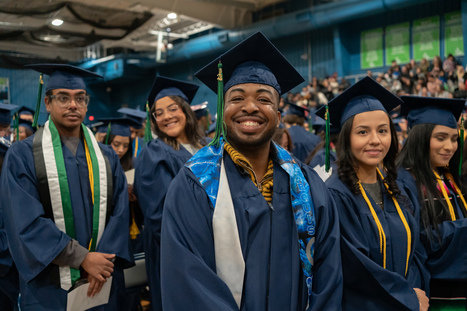 A student smiling at graduation