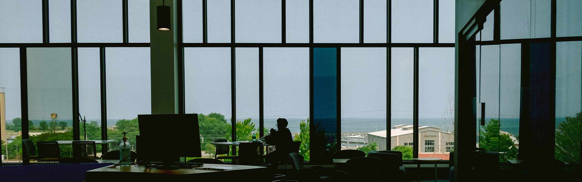 A room with floor to ceiling windows overlooking Lake Michigan