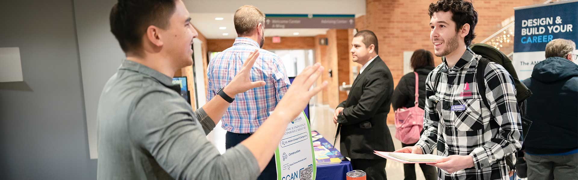 Student talking to employer at campus job fair