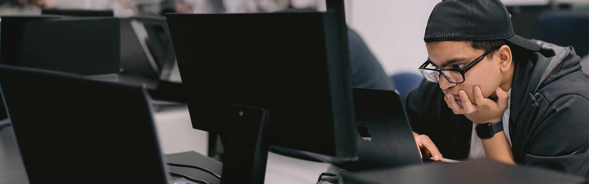 Student intently looking at a computer laptop