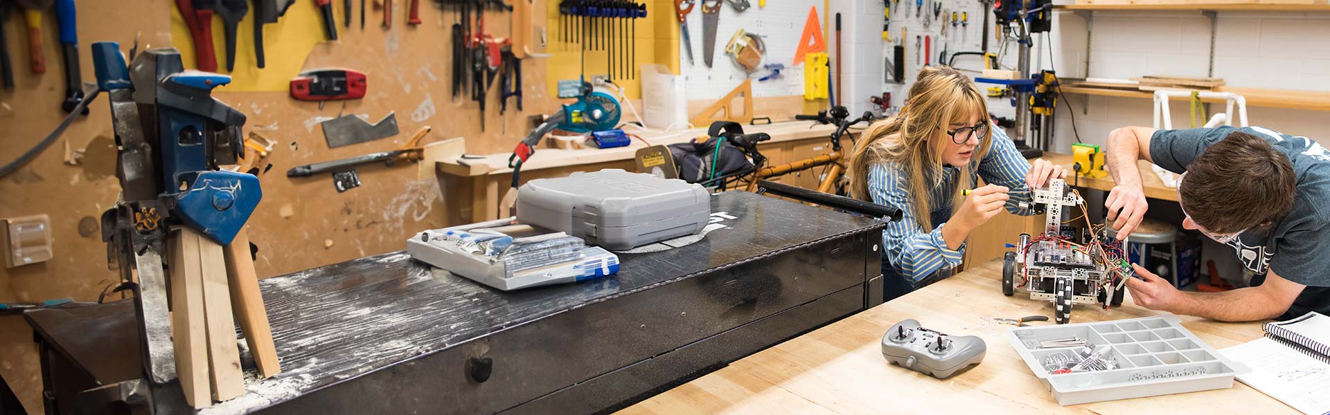 Two students working on a robotic vehicle