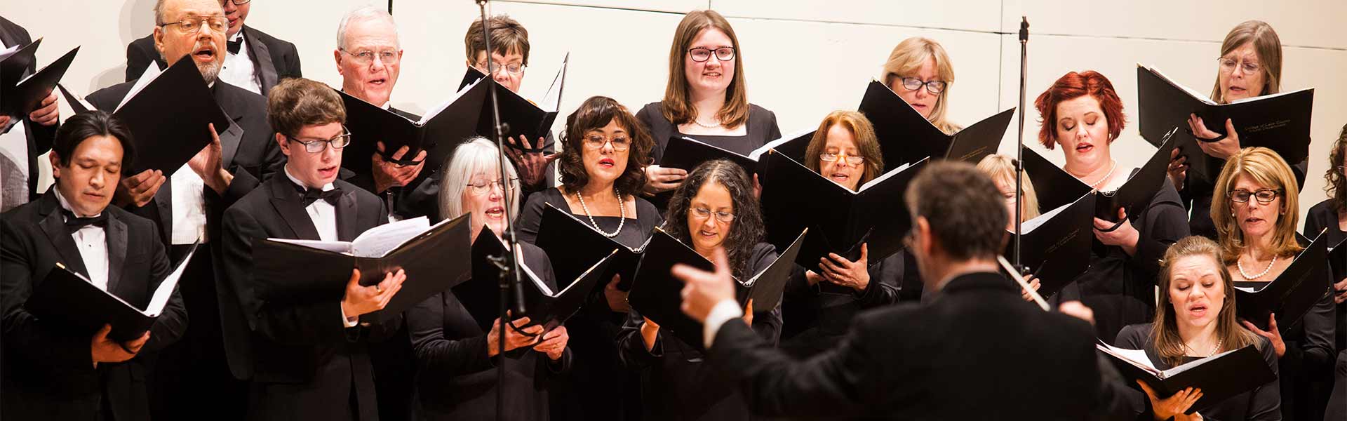 A choral group dressed in black clothing