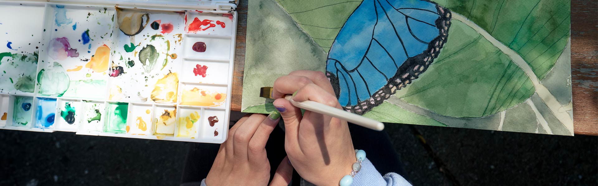 Student painting a butterfly