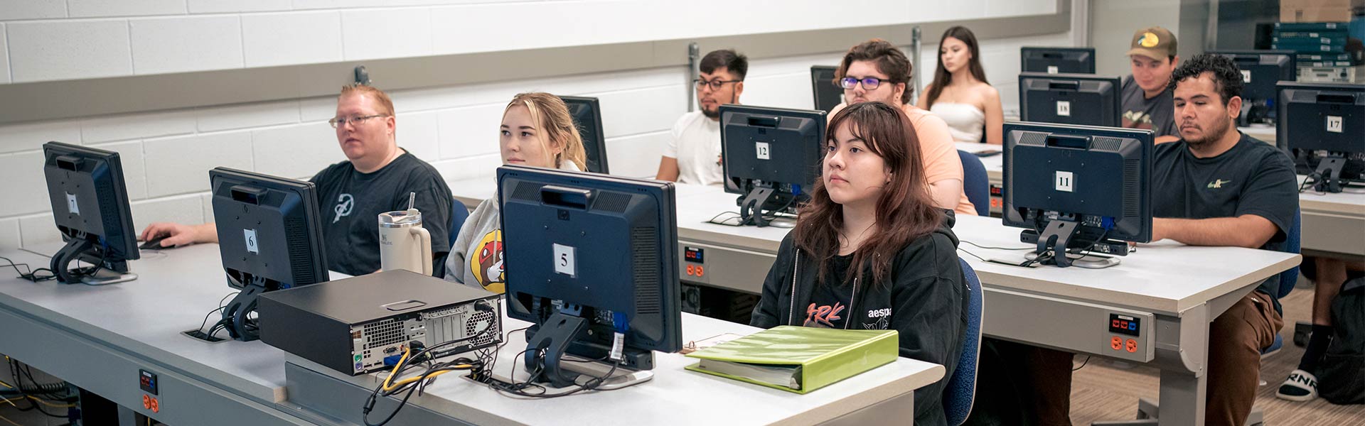 Students at desks listening to professor