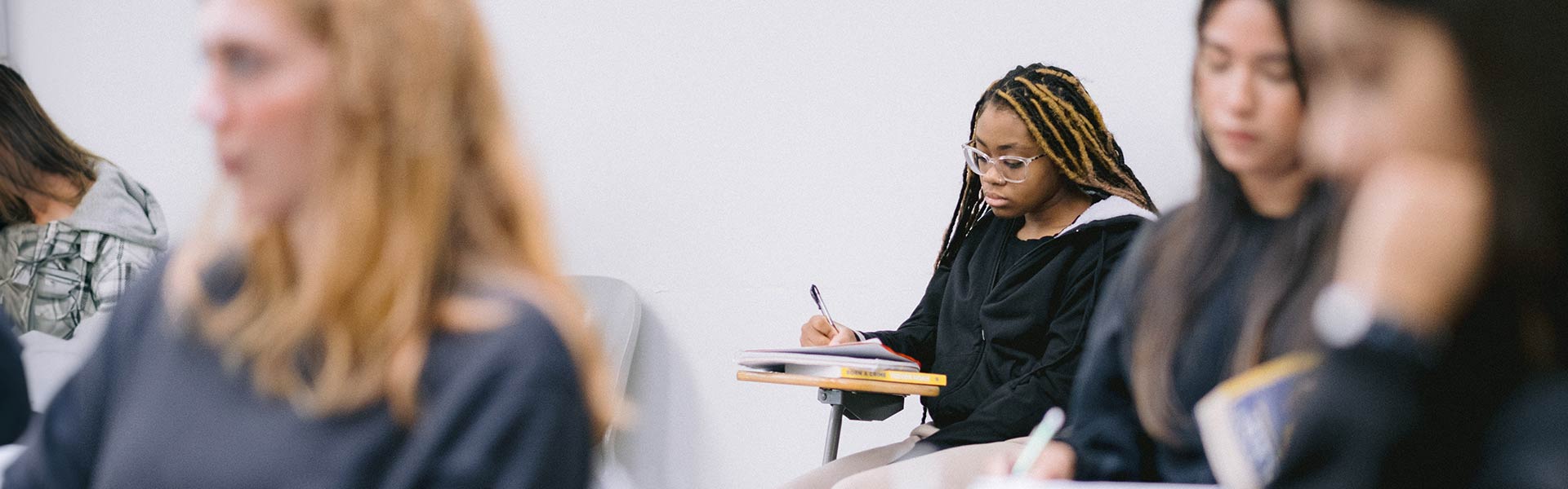 Student taking notes on lecture