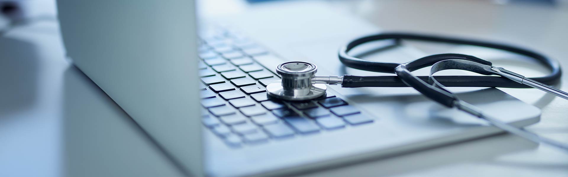 Stethoscope laying on a laptop