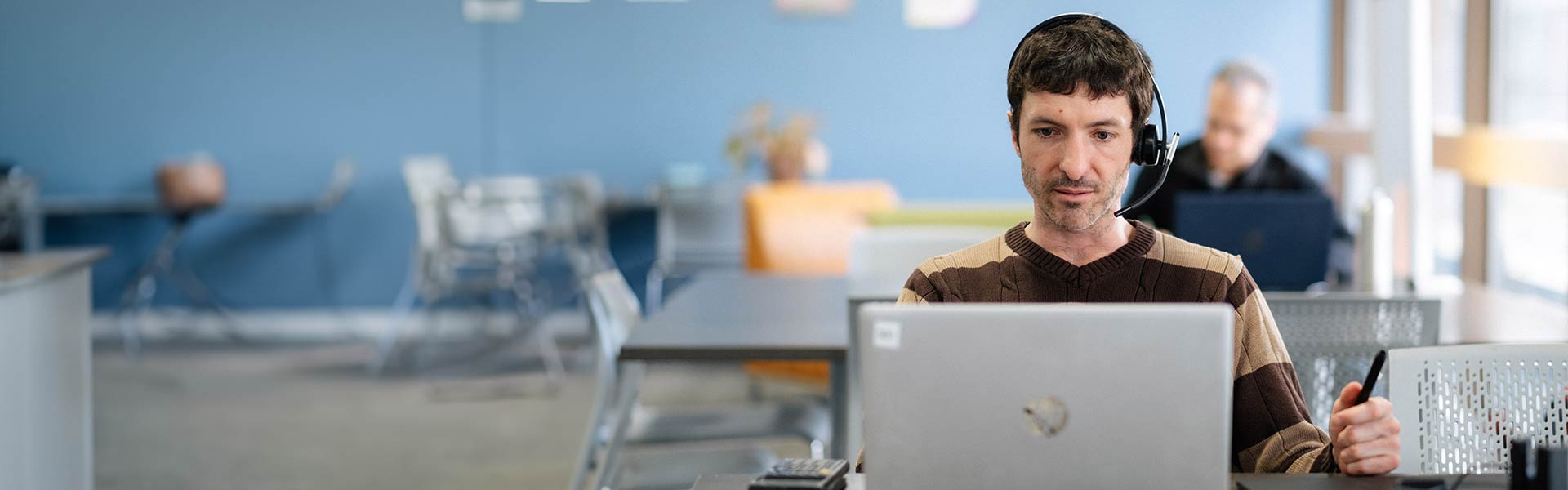 Person sitting at a desk with a computer working