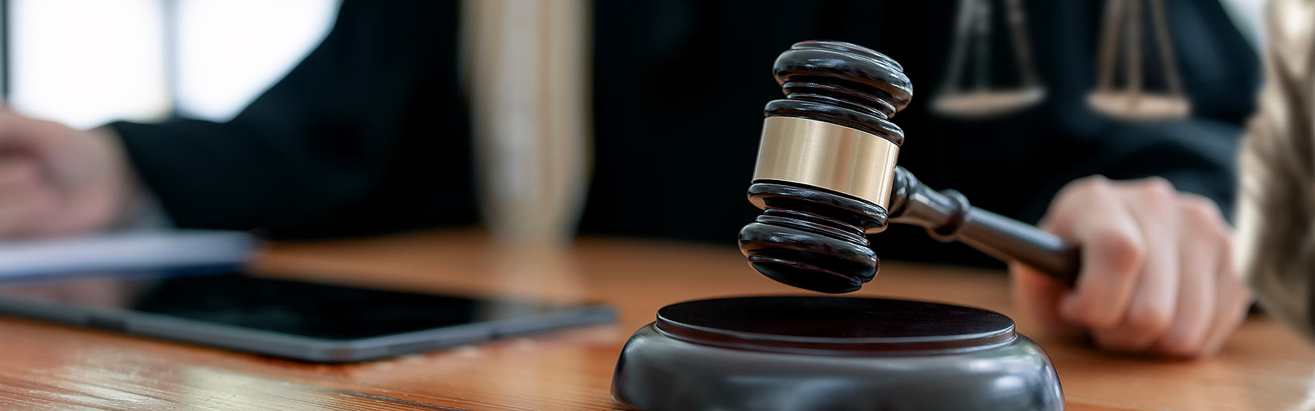 Close up of hand using gavel in a courtroom