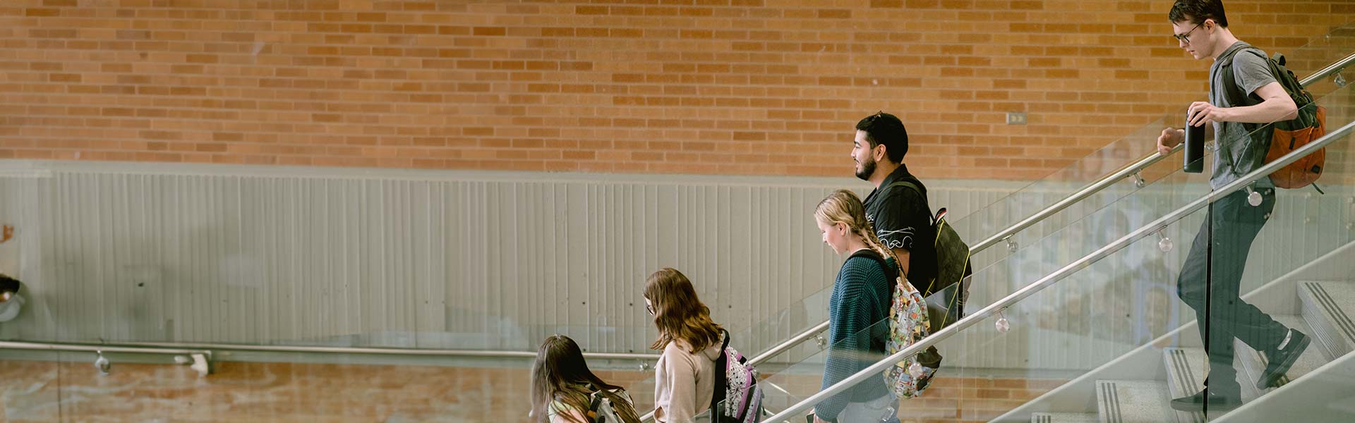 Students walking down college chairs.