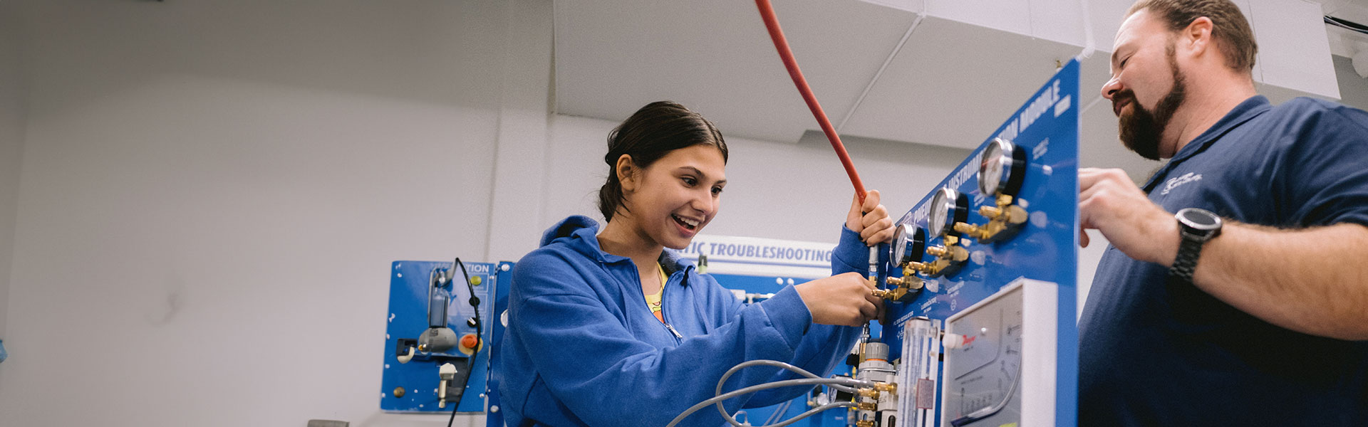 Female high school student working with instructor in class