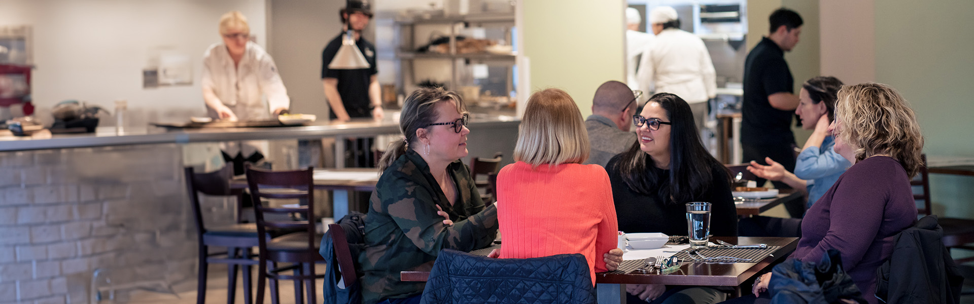 A group of customers sitting at a table in Prairie Restaurant