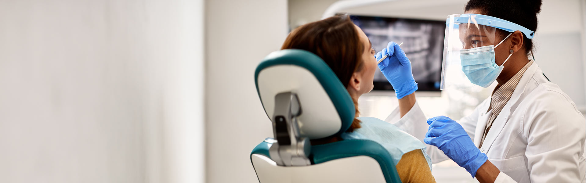 Pre-Dentistry student checking patient's teeth in dental clinic