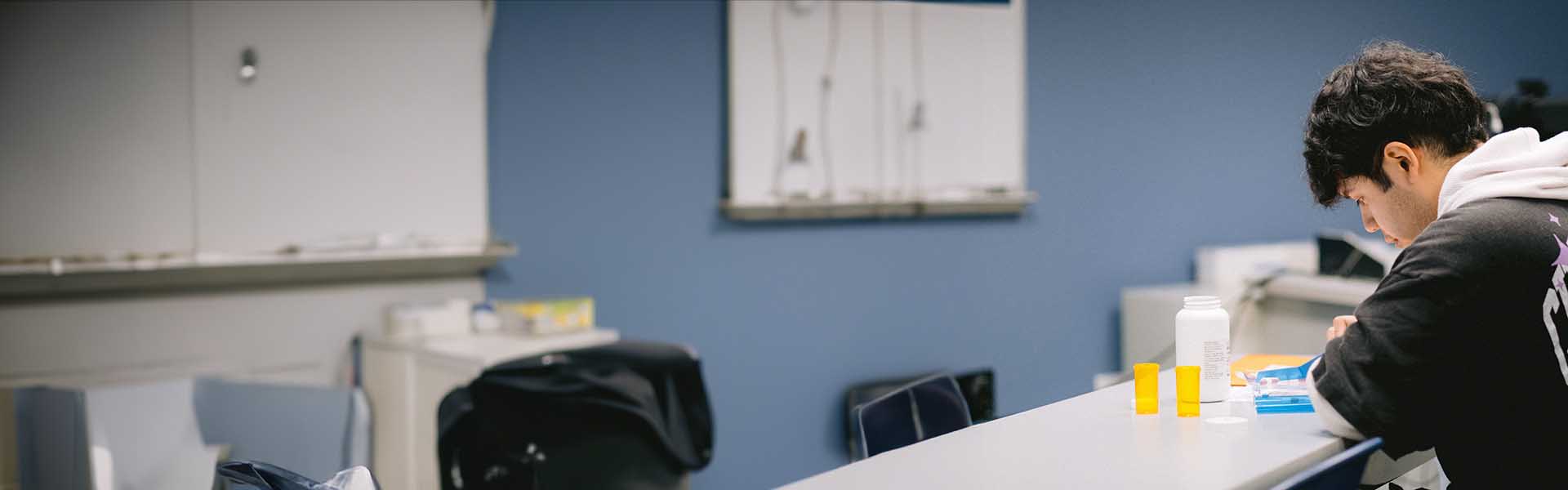 Student in a pharmacy technician lab.