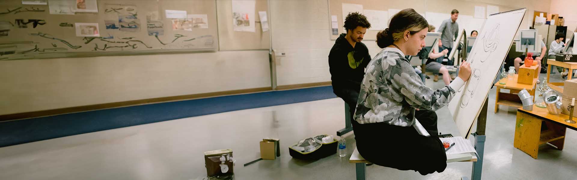 Group of Art students in studio working on their sketches