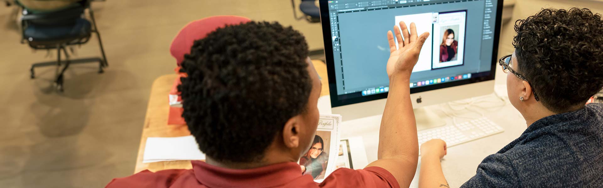 Digital Media and Design students working on a graphic design project in front of computer