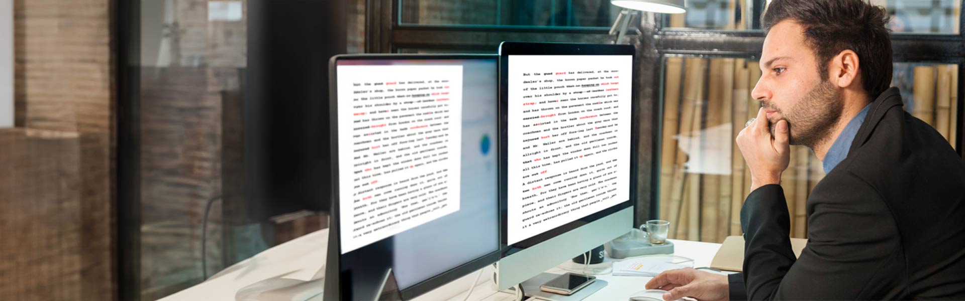 Male student reading text on a computer screen