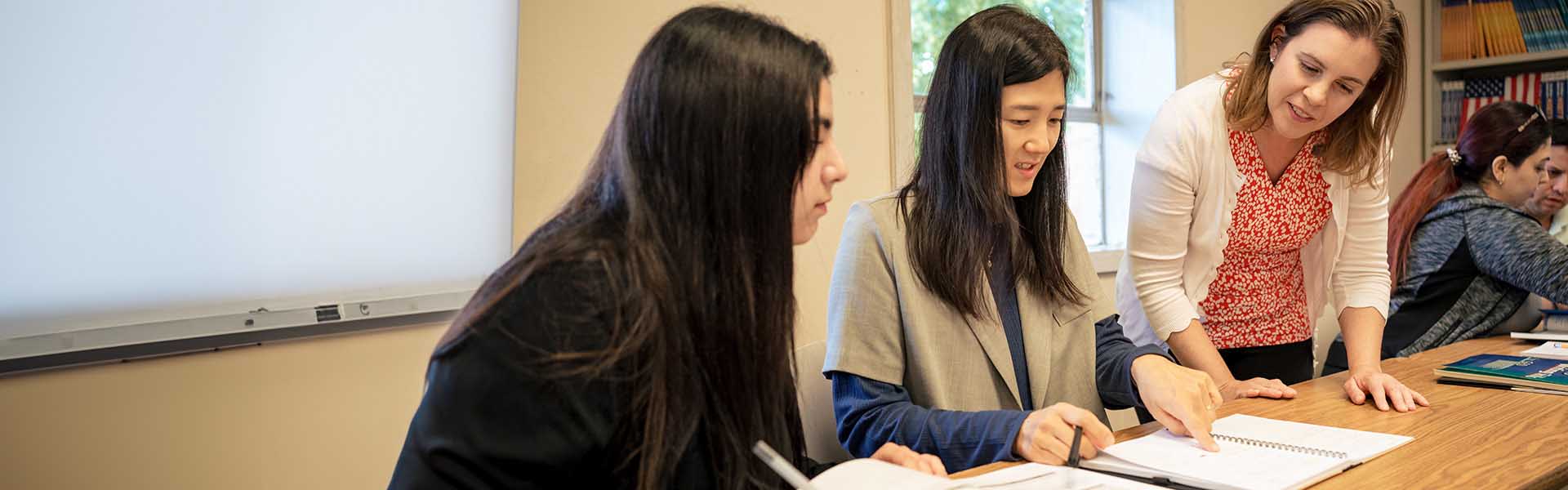 English as a Second Language instructor works with students in class