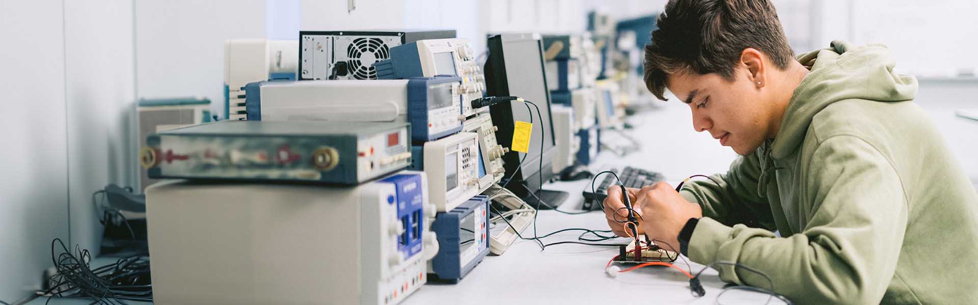 Student working in an electronics lab learning electrical engineering