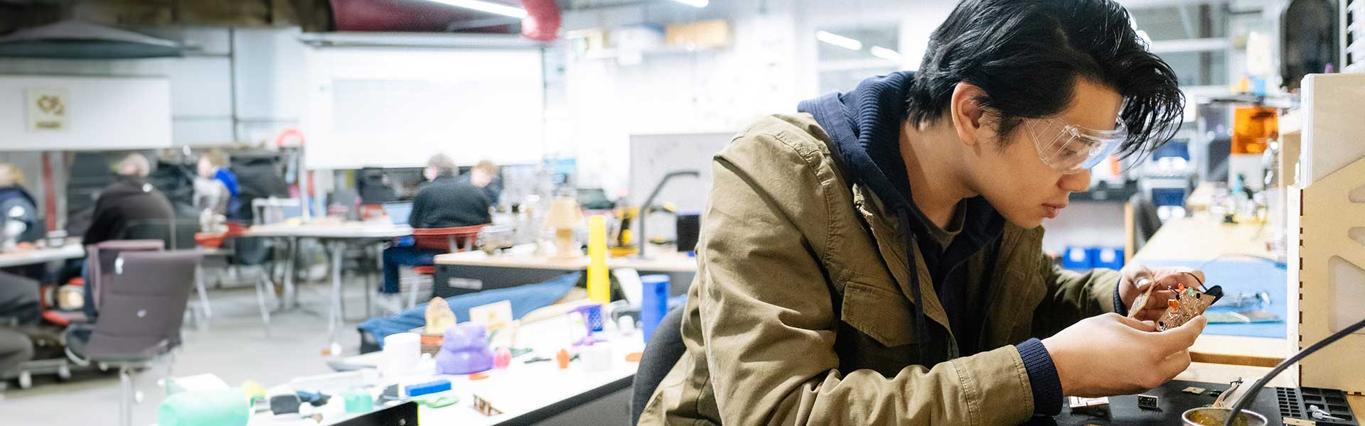 Student intently working with a circuit board