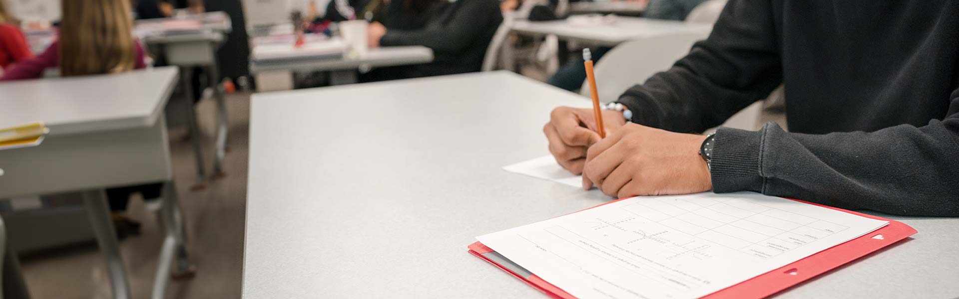 student working on math problems in class