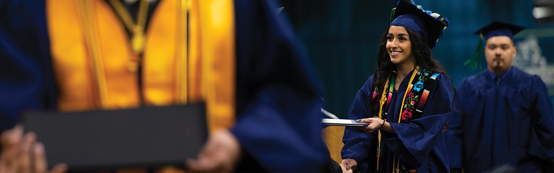 Student walking stage at graduation ceremony