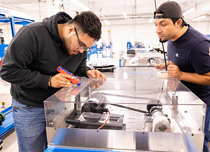 ATC-Foundation Two students working with equipment in the Advanced Technology Center