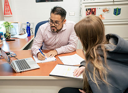 CLC employee helping student with financial aid