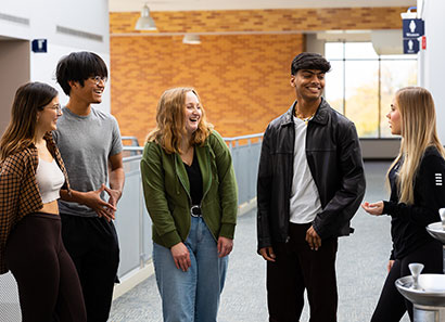 Photo of students talking in the hallway