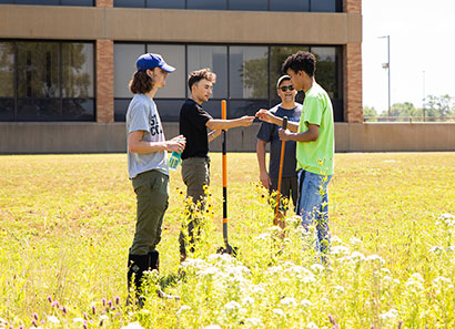 Photo of students working in prairie.