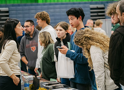 Students talking to a college rep at the Illinois Regional College Fair
