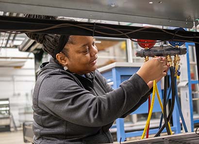 WEI grant funded student works on an HVAC project