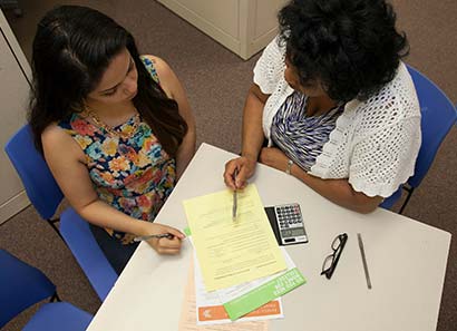 Financial aid representative goes over paperwork with a student