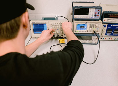 Student tuning electrical equipment