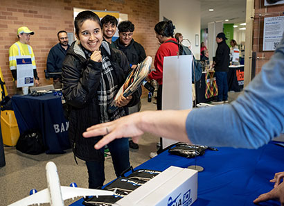 Female student talking to employer at job fair