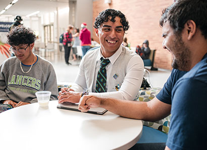 Students laughing while socializing in the student commons